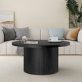 Table basse ronde à piètement cannelé